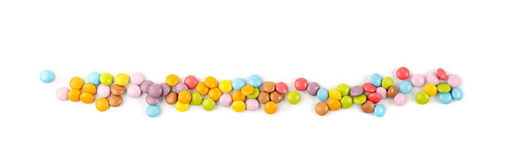 Scattered small candies isolated. Colorful dragees, multicolored glazed chocolate buttons