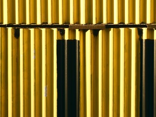 Happy yellow corrugated iron with black and rust hints