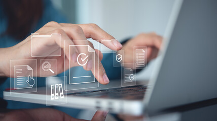 Audit business and document management system concept. Business auditor working on laptop with...