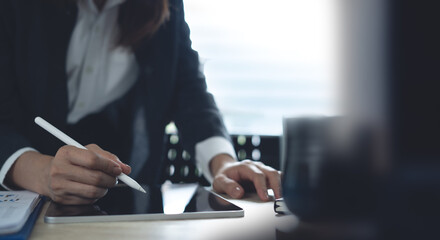 Closeup, Businesswoman using digital tablet, working at modern office. Business woman using stylus...