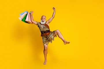 Full size photo of aged savage caveman raise fists store bags empty space leopard skin outfit...