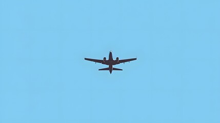 Fototapeta premium Airplane in Flight Against a Clear Blue Sky