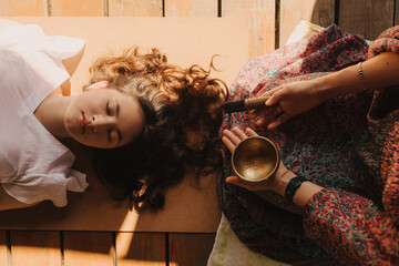 Close up of female mentor and student before Mindful meditation and yoga in the gazebo....