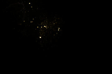 Golden blurred bokeh lights on black background
