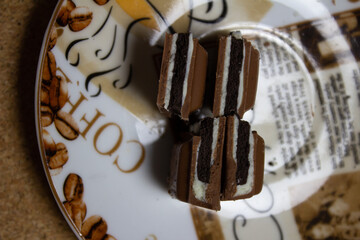 photo of chocolate broken into pieces with filling on a coffee saucer