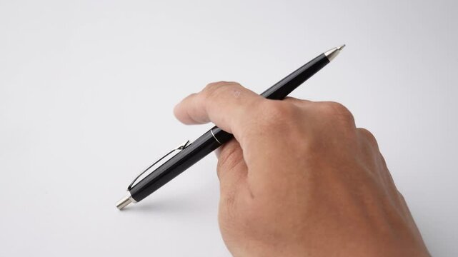Someone is tapping the tip of their pen against the table, a psichological gesture that indicates anxiety, impatience, or boredom. Isolated on white background