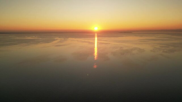 drone smooth video of bright golden hour sunset at the Italian lake Garda Lake 