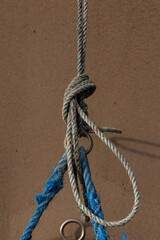 Um close-up de uma corda azul entrelaçadas em um nó, contra um fundo desfocado