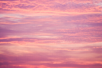 Sunset in the sky in pastel colors. Purple and pink sky with clouds in the evening. Nature...