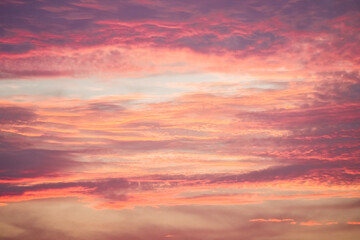 Sunset in the sky in pastel colors. Purple and pink sky with clouds in the evening. Nature background.

