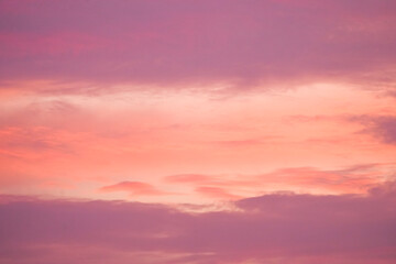 Sunset in the sky in pastel colors. Purple and pink sky with clouds in the evening. Nature background.
