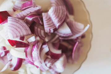 bowl of fresh raw onion slices, top view. chopped onions. liced purple onions. Spanish red onion...