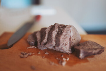 Chef at the pan with roasted meat and vetables. Preparing meal, meat and vegetables. man cutting...