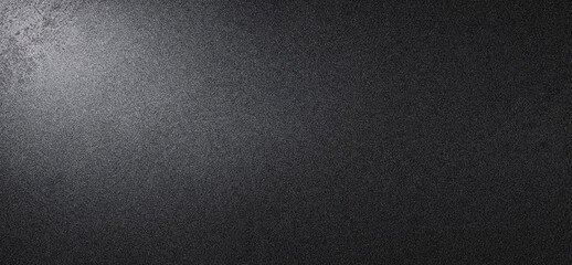 A detailed, high-resolution image of a textured, dark gray surface with subtle variations in tone and light, mimicking frosted or brushed metal, abstract background noise grainy