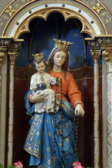 Obraz premium Virgin Mary with baby Jesus, statue on the altar of Our Lady in the parish church of Saint John of Nepomuk in Stupnik, Croatia