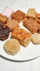 Delicious egyptian pastries showing variety of traditional sweets on white plate at marsa alam sataya resort