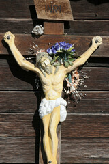 A crucifix on the outer wall of the wooden chapel of Saint Martin in Stari Brod, Croatia