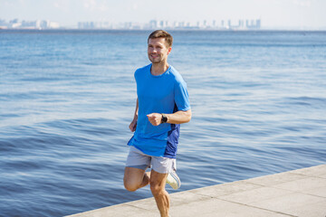 Runner enjoys a sunny morning jog along the waterfront pathway with a scenic city skyline in the...