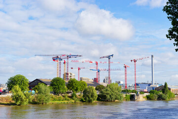 Construction site and cranes  along the Seine river in Paris suburb. Ivry-sur-Seine city