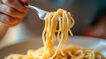 Spaghetti Delight: Close-up shot of a fork twirling delicious spaghetti, showcasing the texture and golden hue of the pasta. The image evokes a sense of warmth and simple pleasure.