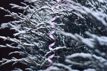 Pink serpentine on a branch, Christmas decor, lone view.