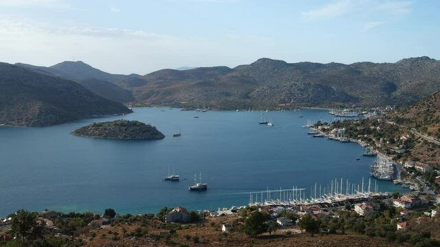 Panoramic view of Bozburun bay from the hill at sunset. Green island and gulet boats. Turkey's cosy holiday village on the Mediterranean Sea. Marmaris district, Mugla province, Turkey - 4k video 