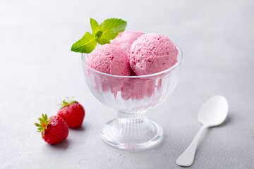 Strawberry Ice Cream in a glass bowl on grey background. Close up. Top view.