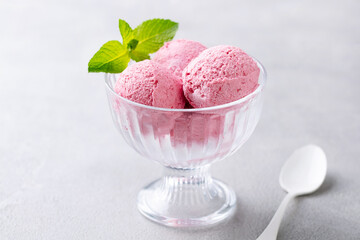 Strawberry Ice Cream in a glass bowl on grey background. Close up.