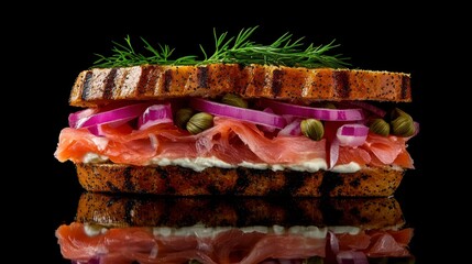 A delicious smoked salmon and cream cheese sandwich on a toasted bagel, topped with capers, red onions, and fresh dill.