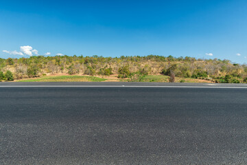 Side view of asphalt road over the hills with blue sky and beautiful mountains, Road background.