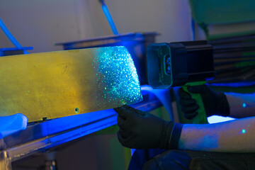 Industrial FPI testing showing fluorescent indications under blacklight examination....