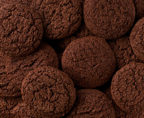 Chocolate brownie cookies with cracks background, Chocolate cookies round shape taken from above,...