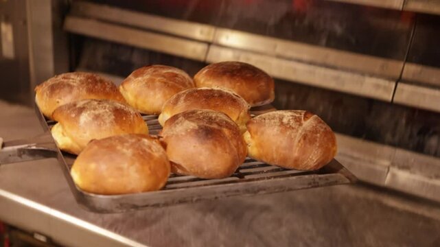 Baker removing golden brown bread