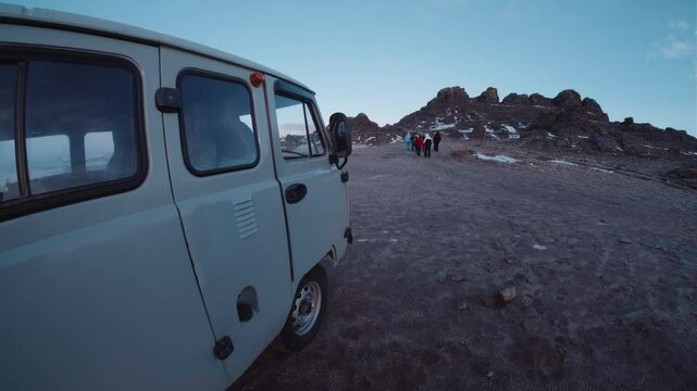 Old Russian UAZ 452 Buhanka bus drives through a pond or lake in the steppe of Siberia. Unpaved road ends in a pond, typical Siberian infrastructure in the vast steppe