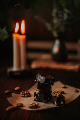 Food photo with chocolate fudge and candles in the background, a concept photo on the theme of Valentine's Day