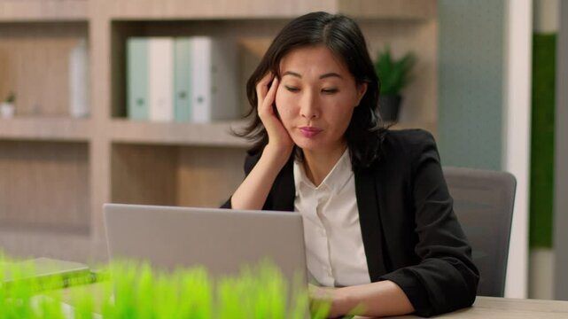 Asian businesswoman Korean female employer bored exhausted Japanese girl Chinese tired business woman sleepy boring online work alone sad upset office manager laptop computer overwork fatigue burnout