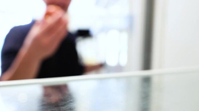 Video of hungry man grabbing an apple in the fridge with his hand to eat it