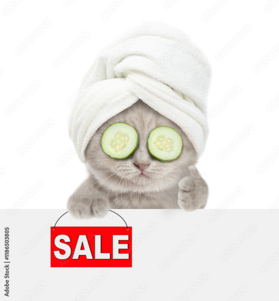 Poster Cute kitten with slices of cucumber on it eyes wearing towel on it head  shows thumbs up gesture and signboard with labeled 