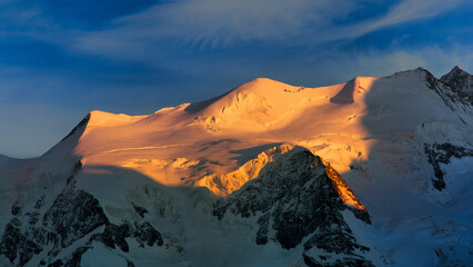 Snow-capped mountains illuminated by the sun
