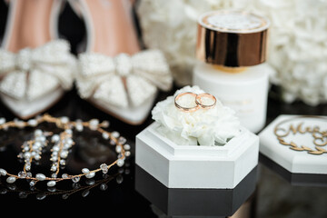 Beautiful wedding bouquet of flowers, gold rings, wedding accessories. Wedding. Details of the bride. White shoes
