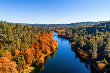 Naklejka premium Scenic Fall Landscape with River and Colorful Trees in Nature