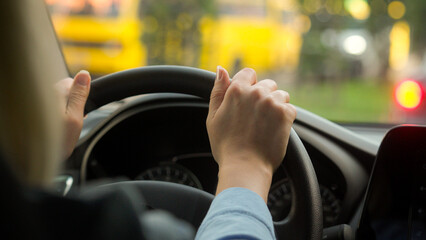 Caucasian girl woman hands female driving rental car driver traveling transport in city automobile...