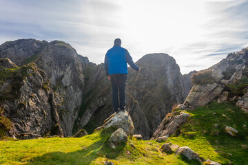 Hiker contemplating majestic view in aiako harria natural park, basque country