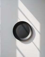 there is a black plate on a white wall with a black plate