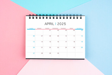 April month desk calendar for 2025 year on colorful background.
