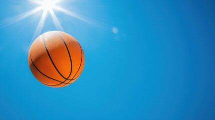 Vibrant Orange Basketball Gliding Through Clear Blue Sky