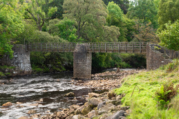 Ramps Holme Bridge, footbridge over the river Swale in Swaledale in the Yorkshire Dales near Muker.