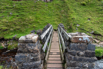 Footbridge at Fair Yew End in the Swinner Gild, which is a wild and remote area in the Swaledale in the Yorkshire Dales National Park.