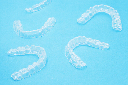 Invisible dental bracket aligners for modern orthodontic treatment to straighten teeth and improve dental hygiene. Cosmetic dentistry orthodontics dental wire teeth brackets teaching student