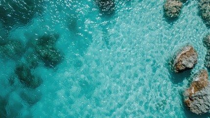 Aerial View of Turquoise Ocean Water with Rocks and Shells Ideal for Travel and Relaxation Themes in Coastal Summer Settings